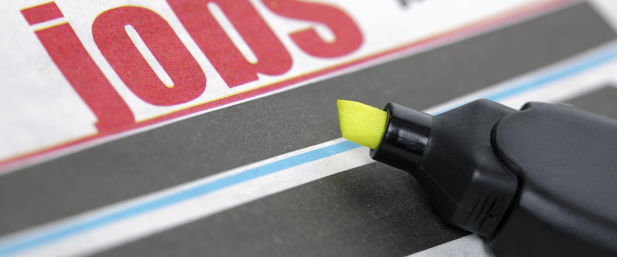 Job listing pages of a newspaper with highlighter pen