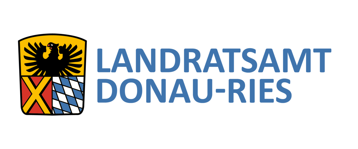 Wappen Landratsamt DONAU-RIES Wappen des Landratsamts DONAU-RIES: auf dem Wappen oben ein schwarzer Adler auf gelbem Hintergrund. darunter links ein gelbes Kreuz auf rotem Hintergrund und rechts davon bayerisches Rautenmuster in weiß-blau. Rechts neben dem Wappen der Text: Landratsamt Donau-Ries.