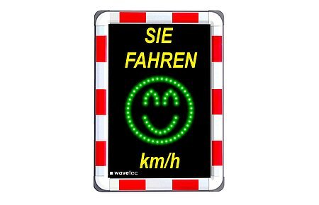 Geschwindigkeitsmessungen Bild eines Geschwindigkeitsmessgeräts im Straßenverkehr, darauf oben gelber Text "Sie fahren" und unten "km/h". Dazwischen ein grünes Smiley-Gesicht aus LEDs. Der Rand außen ist rot/weiß.