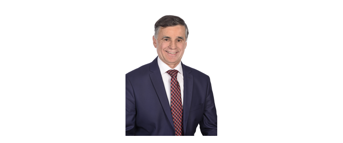 1. Bürgermeister der Stadt Monheim Günther Pfefferer: Ein Mann in Anzug mit kariertem Schlips, lächelnd, vor weißem Hintergrund.